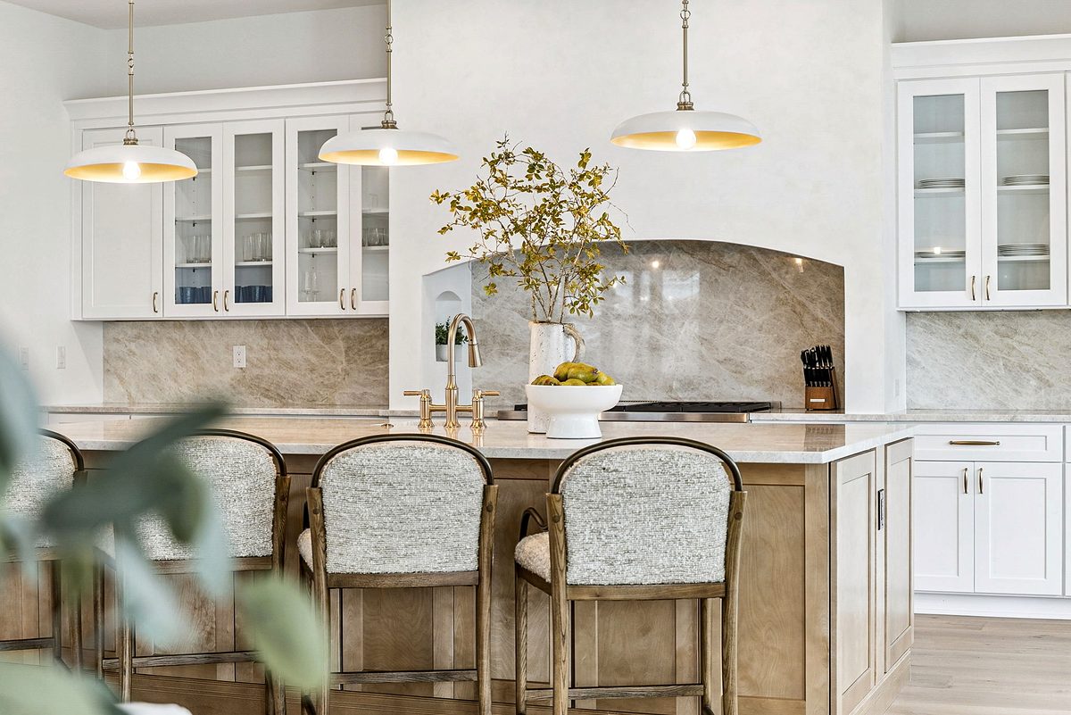 White kitchen with a wood island. Home designed by Jason Mundy.
