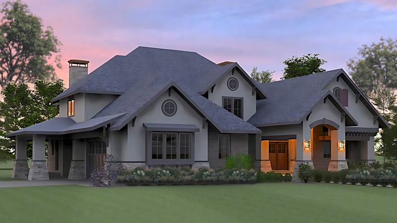 Photorealistic rendering of a stucco and stone Craftsman-style home at sunset with a gray shingle roof, round gable vents and lantern-lit entry porches.
